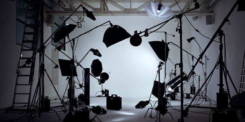 Product photography studio with lighting equipment around the table